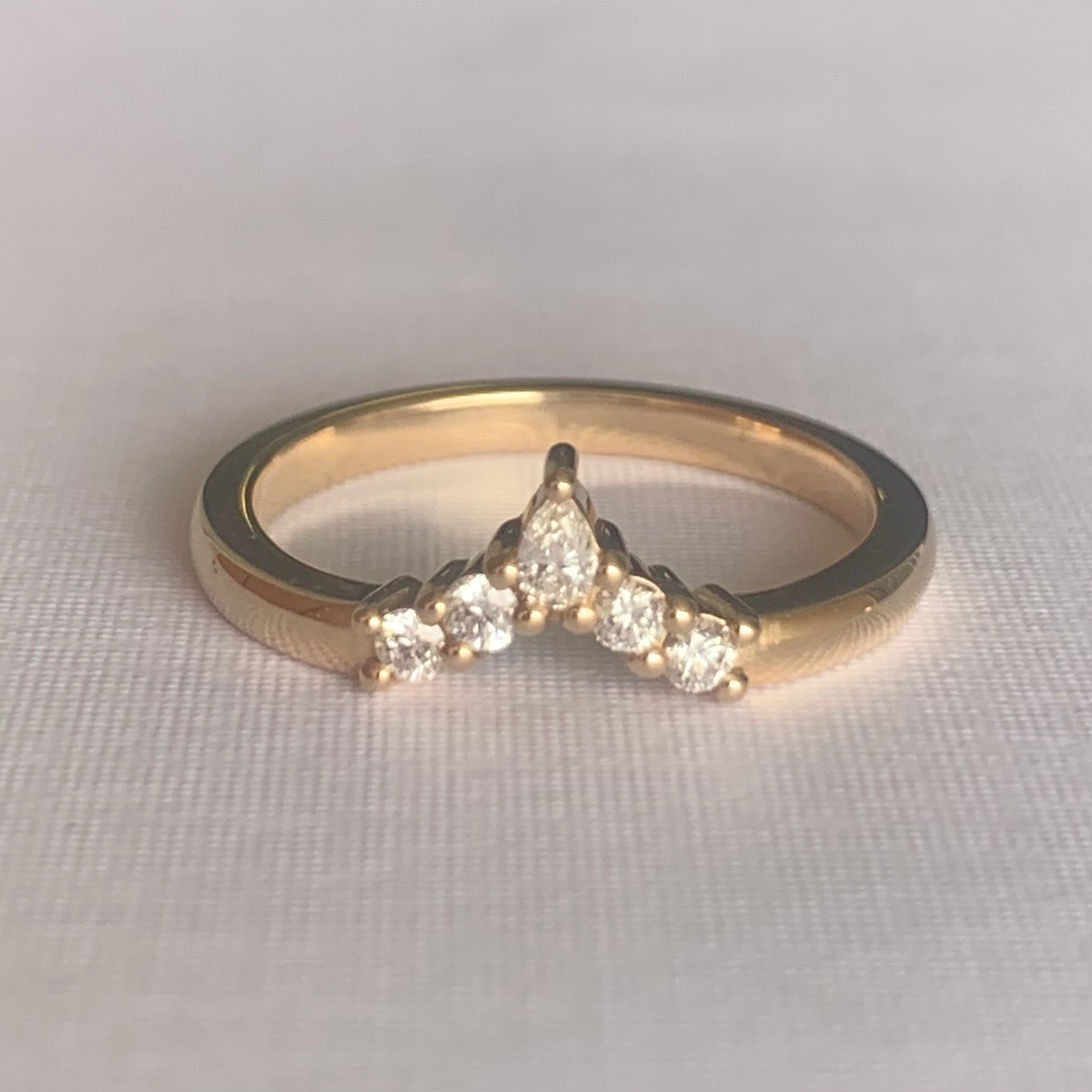 Viola Diamond V Band  Band width 2mm  Finger Size O  14ct Yellow Gold  Complimentary first Size  The Diamonds are Colour F clarity VS featuring four 2mm round brilliant cuts and one 4 x 2mm pear cut diamond.  Made with recycled metal in Sydney   Ethically sourced Gemstones